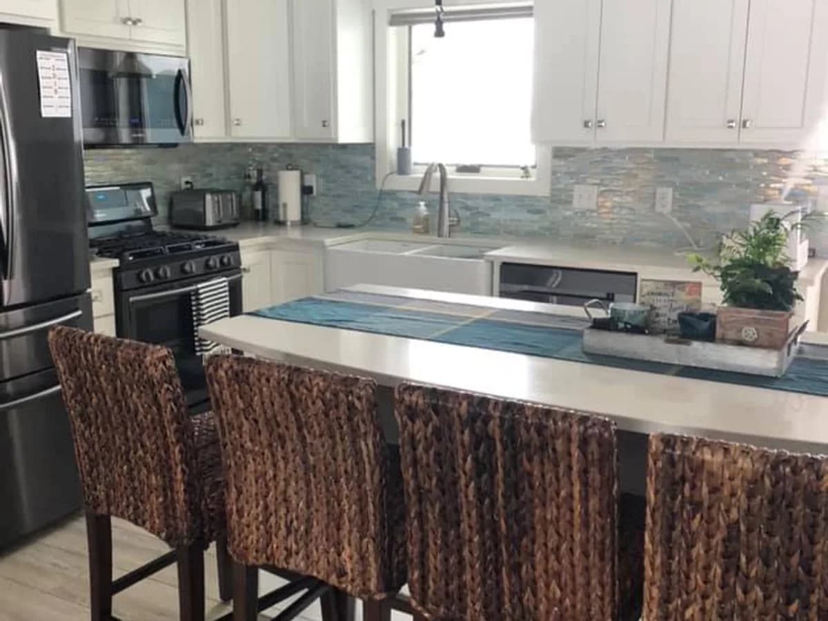 the same kitchen with clear counters, island and floor area after professional house cleaning